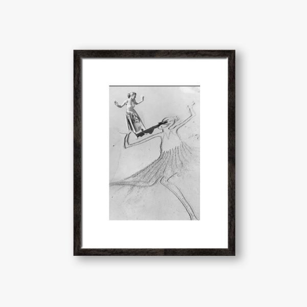 a framed photograph of a woman on a beach