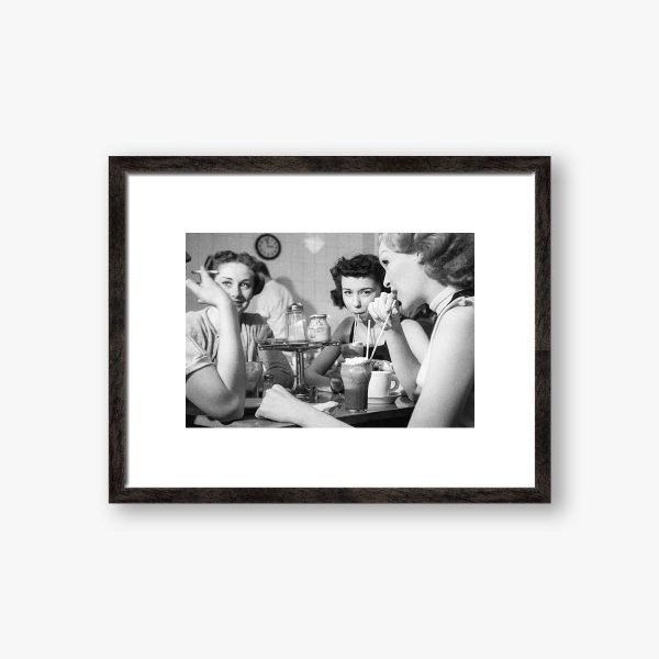 a black and white framed photograph of girls drinking milk shakes and smoking